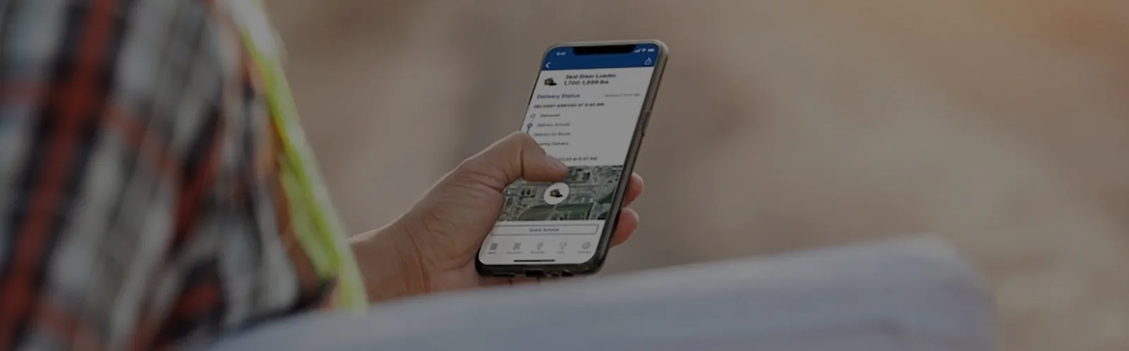 Mobile App held in hand by worker