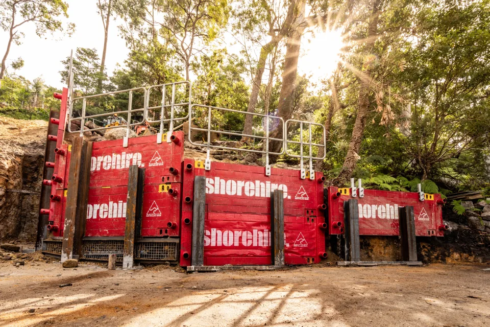 Temporary post and panel wall system enclosing a construction site to enhance safety, security, and dust control.