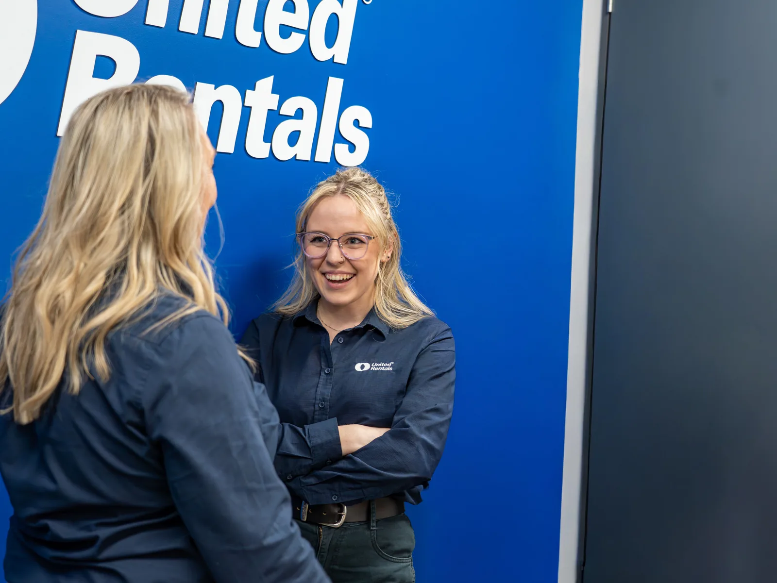 staff in office united rental back drop