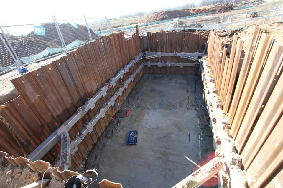 Trench sheets and sheet piles installed around an excavation site to support soil and ensure trench safety during digging.