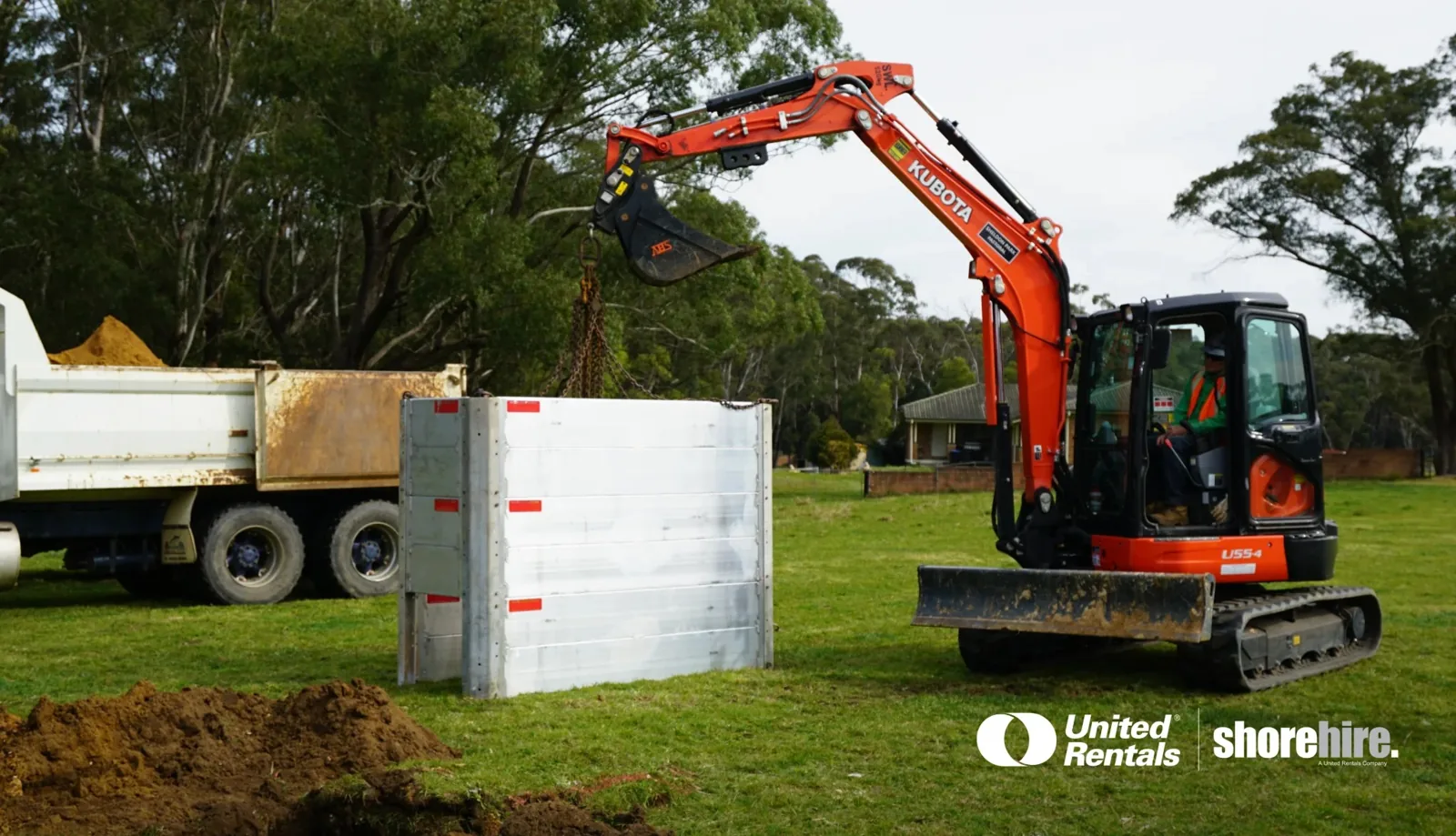 Modular Aluminium Panel Shields (MAPS) being carried with an excavator to be installed under ground