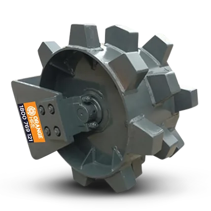 Compaction wheel attachment on an excavator, used to compress soil on a construction site with safety barriers nearby.