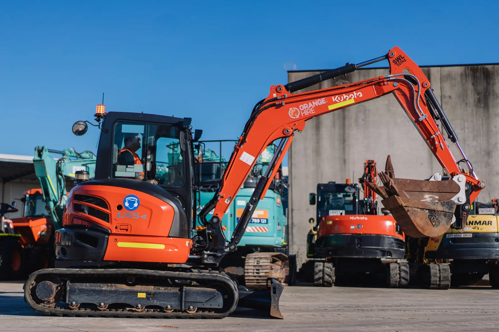 Technician performing maintenance on construction equipment to ensure safe and reliable operation at work sites.