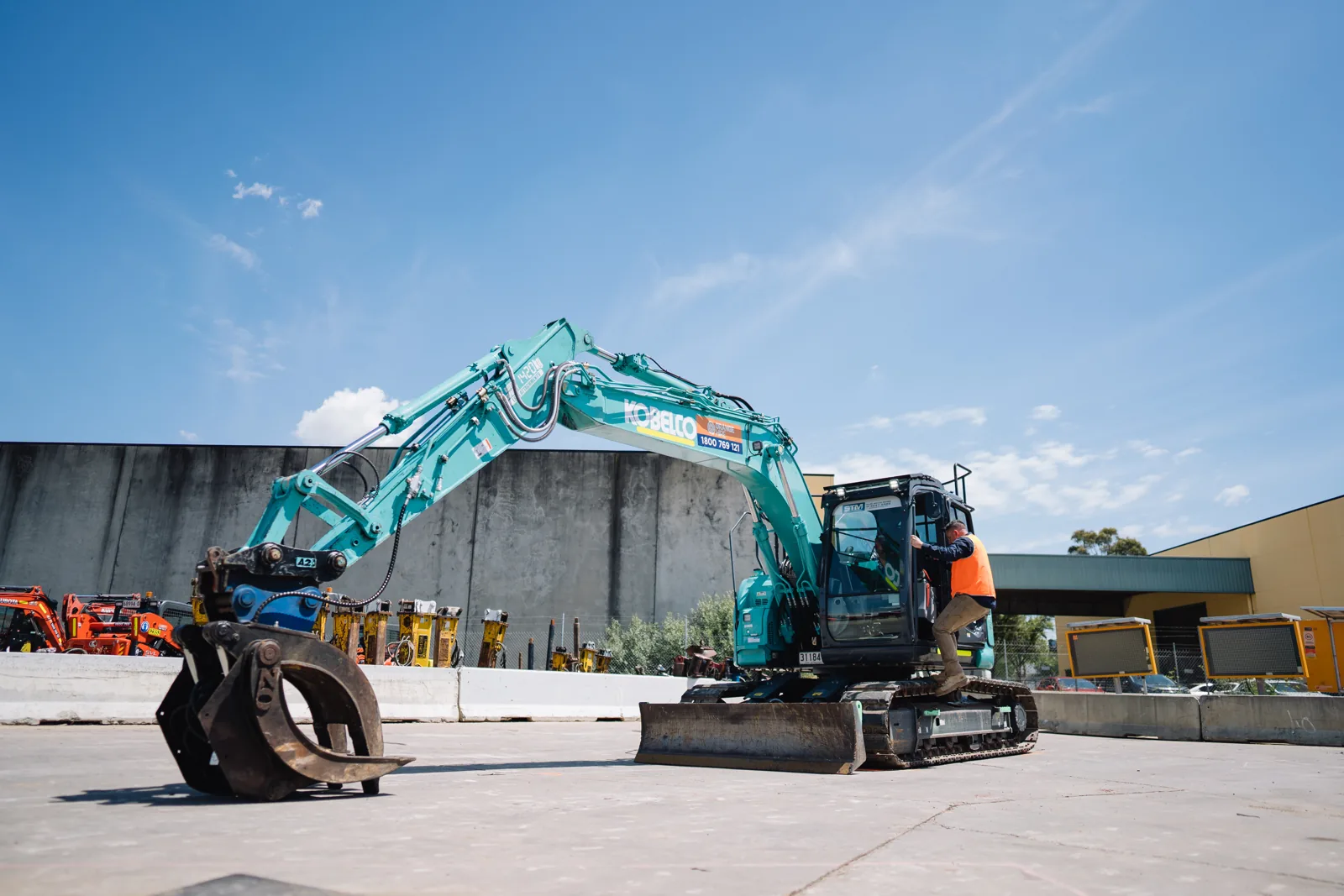 Orange Hire Excavator In yard