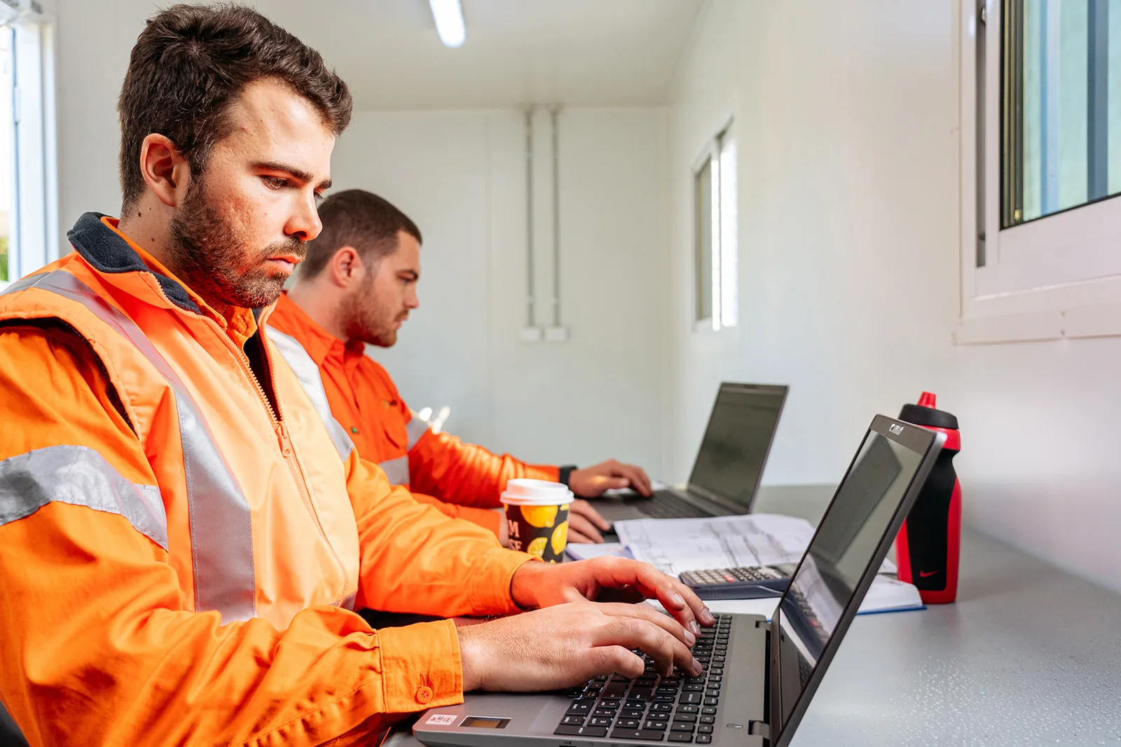 Man in mobile storage container working on computer